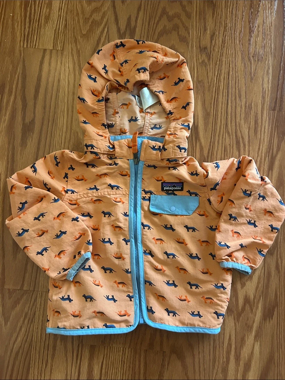 Patagonia Kids Orange Jacket with Blue Trim and Animal Print